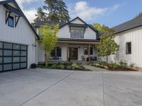 a house that has a large driveway in front of it that's surrounded by trees