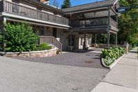 this large house has two floors and porches on the second floor, while the fourth story looks out onto the street