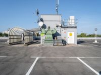 a large factory sitting on top of a metal fence with a light pole and roof