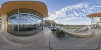 a fish eye view of the outside of a building and a building in the distance