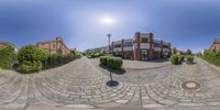 fish eye lensing view of the building next to the street with cobblestone pathway