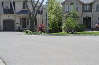 a neighborhood with two rows of houses and trees outside the house is empty from the front door