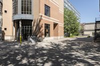 a picture of some buildings on a sunny day and one is empty with chairs on the sidewalk and there are no people or vehicles outside