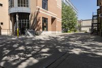 a picture of some buildings on a sunny day and one is empty with chairs on the sidewalk and there are no people or vehicles outside