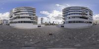 two circular sculptures are displayed on the pavement in this 3d photo the image is in different angles