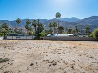 a dirt field with mountains in the background at a residential property area that is being sold