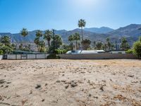 a dirt field with mountains in the background at a residential property area that is being sold