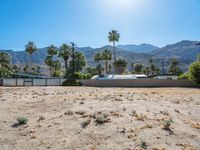 a dirt field with mountains in the background at a residential property area that is being sold