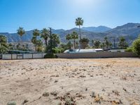 a dirt field with mountains in the background at a residential property area that is being sold