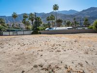 a dirt field with mountains in the background at a residential property area that is being sold