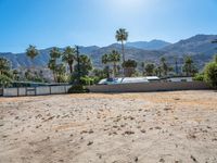 a dirt field with mountains in the background at a residential property area that is being sold