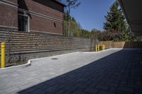 an outdoor space in between a fence and a building on a clear day with no people or cars