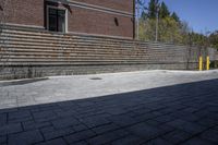 an outdoor space in between a fence and a building on a clear day with no people or cars