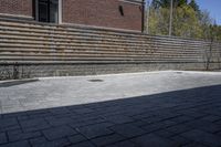 an outdoor space in between a fence and a building on a clear day with no people or cars