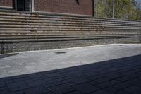 an outdoor space in between a fence and a building on a clear day with no people or cars