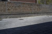 an outdoor space in between a fence and a building on a clear day with no people or cars