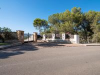 large driveway area in front of large residential estate and gated area with stone pillars