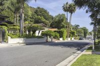 a residential road surrounded by trees and hedges and a sign for a parking area on the side