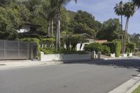 a residential road surrounded by trees and hedges and a sign for a parking area on the side