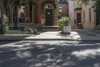 the corner of a residential road is pictured with a tree on it's right side