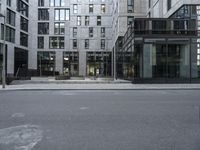 the empty street with a number of buildings in the background that appear to be in different places