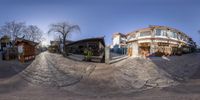 a fisheye image shows the street outside of a house with no one out side