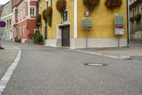 a street corner with no one on it, and signs on the side of the building