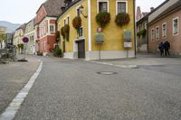 a street corner with no one on it, and signs on the side of the building