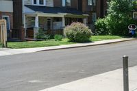 a row of houses and a fence line a street with a parking meter in the foreground