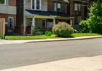 a row of houses and a fence line a street with a parking meter in the foreground