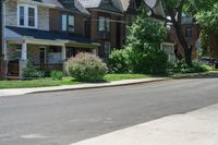 a row of houses and a fence line a street with a parking meter in the foreground