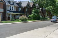 a row of houses and a fence line a street with a parking meter in the foreground