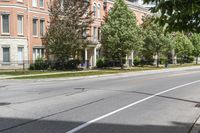 a street with buildings and a blue fire hydrant on it's curb and sidewalk