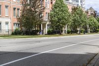 a street with buildings and a blue fire hydrant on it's curb and sidewalk