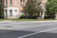 a street with buildings and a blue fire hydrant on it's curb and sidewalk