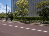 empty road with white lines on the streets of city area against cloudy blue sky on a sunny day