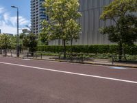 empty road with white lines on the streets of city area against cloudy blue sky on a sunny day