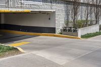 two people in a parking garage attached to an awning and a bicycle on a sidewalk