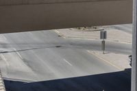 this photo shows an intersection of roads with a clock tower next to a highway above which is in motion