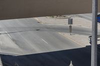 this photo shows an intersection of roads with a clock tower next to a highway above which is in motion