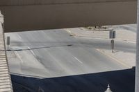 this photo shows an intersection of roads with a clock tower next to a highway above which is in motion