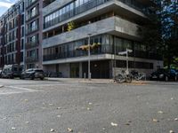 A serene landscape featuring a calm lake reflecting the surrounding mountains under a clear blue sky. Lush green trees line the shore, and a small wooden dock extends into the water. In the foreground, vibrant wildflowers add splashes of color, while distant peaks are capped with snow, creating a picturesque natural scene.