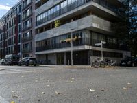 A serene landscape featuring a calm lake reflecting the surrounding mountains under a clear blue sky. Lush green trees line the shore, and a small wooden dock extends into the water. In the foreground, vibrant wildflowers add splashes of color, while distant peaks are capped with snow, creating a picturesque natural scene.