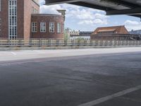 a person is riding a bike on a bridge by some buildings with lots of windows