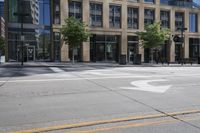 a motorcycle is riding down the road next to a city street and many buildings on both sides