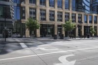 a motorcycle is riding down the road next to a city street and many buildings on both sides