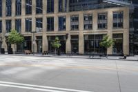 a motorcycle is riding down the road next to a city street and many buildings on both sides