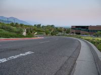 a building that has a bunch of windows on it at sunset with mountains in the background