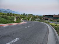 a building that has a bunch of windows on it at sunset with mountains in the background