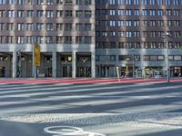 a red light at an intersection on the side of a building with a bicycle lane